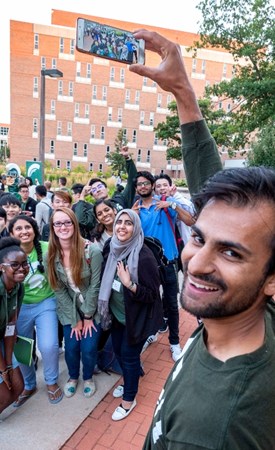 Students preparing to take a group photo on MSU's campus